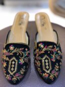 Black open khussa with colorful floral thread embroidery and gold sequin medallion, slingback style
